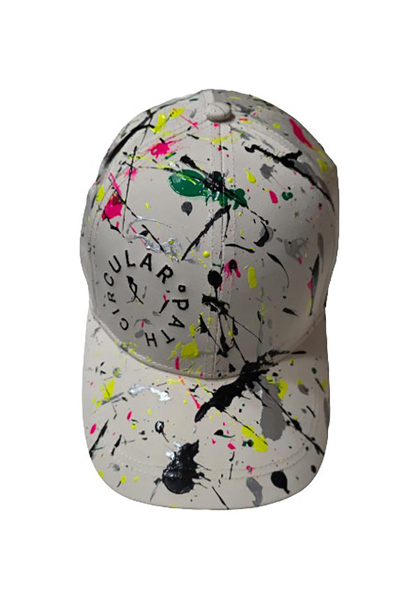 Baseball cap with colorful splatter design on a white background